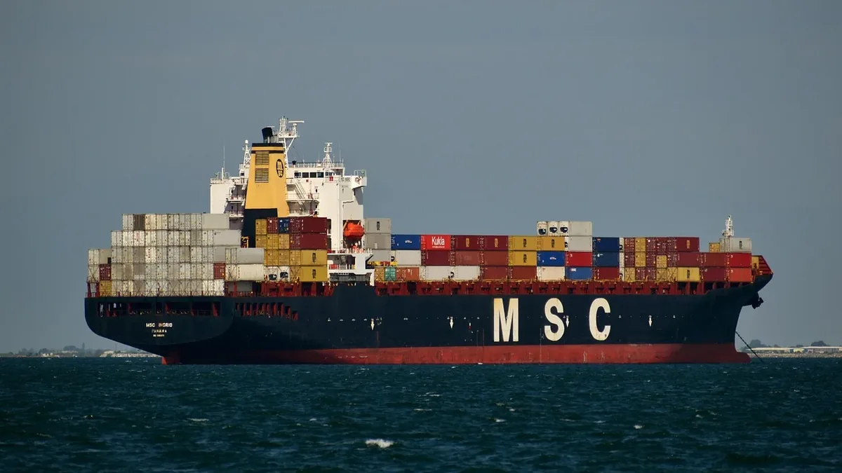A large cargo ship with the letters "MSC" on its side, floating on a body of water.